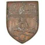 A bronzed cast lead example of the Warsaw shield, pierced around the edge with 4 small holes for