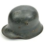 A German WWI M18 steel helmet, painted grey, with later Luftschutz style leather liner and