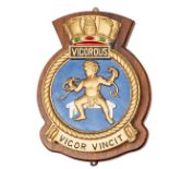 A painted, cast, official badge of HMS Vigorous, V class submarine 1943-49, showing infant holding 2