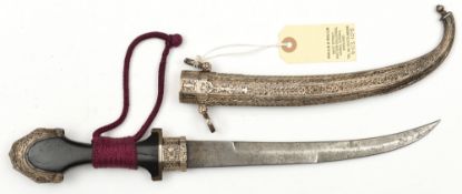 An early 20th century Moroccan jambiya, curved blade 9¼”, DE towards tip, ebony hilt, Eastern silver