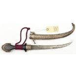 An early 20th century Moroccan jambiya, curved blade 9¼”, DE towards tip, ebony hilt, Eastern silver