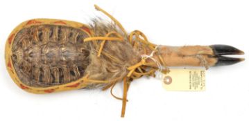 A N American Indian rattle, formed from a tortoiseshell with a goats foot handle, held together with