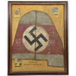 A tail fin shaped section of canvas painted with a swastika, purporting to be from a pre war