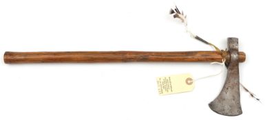 An Indian tomahawk style axe, simple blade 2½”, plain haft, 18” overall, with feather tassel (worn).