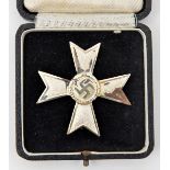 A Third Reich War Merit Cross 1st class without swords, in its original box with silver cross on the