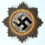 A Third Reich German Cross in gold, with 4 hollow rivets to the reverse and maker’s code “20” on the