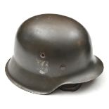 A Third Reich M42 single decal steel helmet, with maker’s mark “ckl64” (Eisenhuttenwerke), and lot