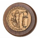 A cast brass circular badge of HMS Clio, sloop, 1903-20, showing Clio, the Muse of History,