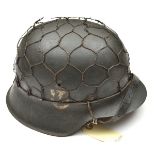A Third Reich M42 single decal steel helmet, with maker’s mark “khp66” (Saschsische Emaillier u