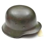 A Third Reich M42 steel helmet, with indistinct maker’s mark and lot number, the skull with smooth