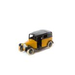 A rare Dinky Toys Taxi (36g). An example in yellow and black with open rear window, black smooth