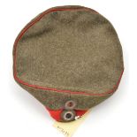 A WWI Prussian cap, feldmutz, of field grey with red band and piping and national and state