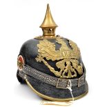 A Prussian pickelhaube, with brass mounts and plate, and replacement chin strap and rosettes. QGC (