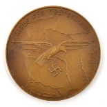 A Third Reich bronze medallion, the obverse depicting Luftwaffe eagle over a map of Germany and