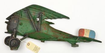 A flat painted cast iron representation of a WWI British bi-plane, with two flat “feet” to allow