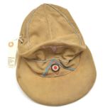 A Third Reich pale khaki soft visored cap, with blue/grey embroidered eagle, cockade on light