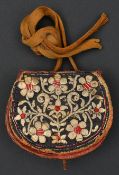An Ottoman leather bullet pouch.19th century, 11 cms flap front and sides covered with fabric