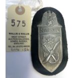 A Third Reich Narvik arm shield, of grey metal on black cloth patch with backing plate. GC