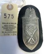 A Third Reich Narvik arm shield, of grey metal on black cloth patch with backing plate. GC