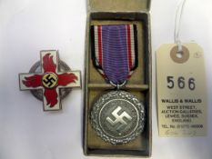 A Third Reich 1st type 1st class Fire Brigade decoration, 43mm type, the swastika on yellow