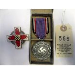 A Third Reich 1st type 1st class Fire Brigade decoration, 43mm type, the swastika on yellow