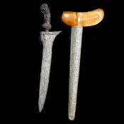 A Javanese dagger kris. 19th century, broad straight pamor blade 28.5cms, foliate carved wooden
