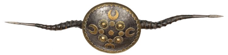 An Indian Hindu mendicant's parrying shield madu. 19th century 76cms overall, iron shield with brass