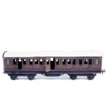 A Bing for Bassett-Lowke Gauge One tinplate GWR bogie coach. Full First class, in lined brown