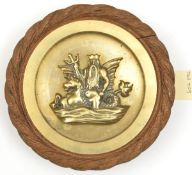 A small cast brass tompion badge of HMS Neptune, battleship 1909-22, showing the sea god holding