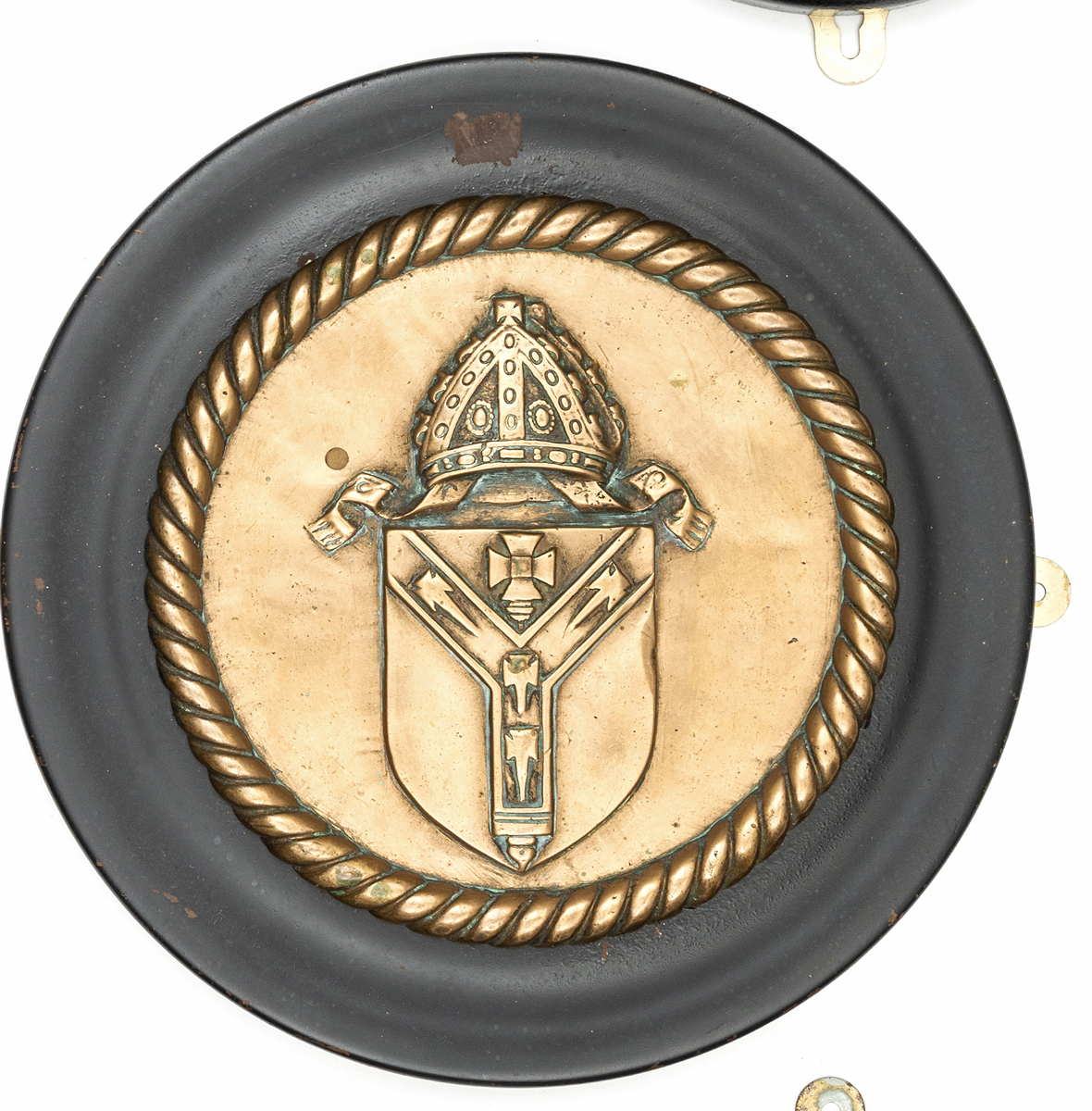 A cast brass circular badge of HMS Canterbury, cruiser 1915-34, showing the Arms of Canterbury