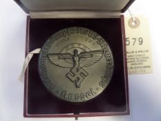 A Third Reich NSFK uniface medallion, of blackened alloy, 80mm diameter, embossed with the NSFK