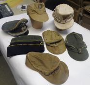 7 various German ski type caps, 3 side caps, and 2 officers caps, with various Third Reich insignia,