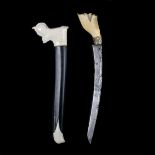 A Malayan dagger bade bade. 19th century, curved slender SE blade 21.5cms, hippo ivory hilt and