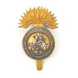 An officer’s gilt and silver plated cap badge of The Northumberland Fusiliers, single lug and
