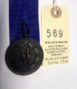 A Third Reich SS 4 year long service medal, with a length of unused 30mm wide blue ribbon. GC