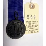 A Third Reich SS 4 year long service medal, with a length of unused 30mm wide blue ribbon. GC