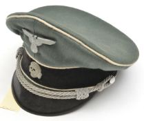 A Third Reich Waffen SS officer’s cap, with black velvet band, white piping, grey metal eagle and