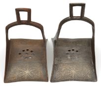 A pair of North African iron stirrups. 20th century, 20cms, of conventional form with integral