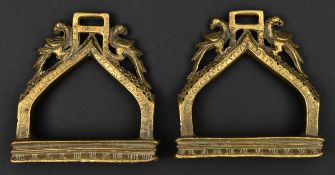 A pair of South Indian cast brass hollow stirrups. Probably 19th century, each bow engraved and