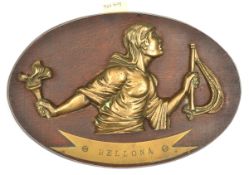A cast brass badge of HMS Bellona, cruiser 1909-21, showing the Roman goddess of War, head (
