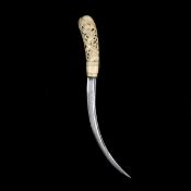 A Burmese knife. Late 19th century, associated slender curved SE blade 25.5cms, ivory hilt carved