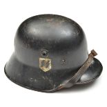 A Third Reich period M16 steel helmet re-issued to the Allgemeine SS, the skull bearing “ET” maker’s