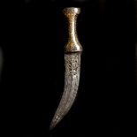 An Indian dagger jambiya. Late 19th century, curved DE blade 17cms chiselled with Hinu divinities at