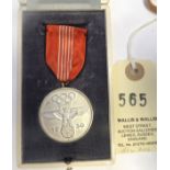 A Third Reich Olympic Games commemorative medal, with ribbon and pin suspender, in its fitted