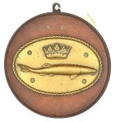 A cast brass oval badge of HMS Sturgeon, destroyer 1917-26, showing a sturgeon with coronet above,