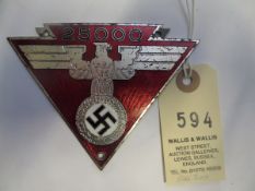 A Third Reich car dashboard (?) triangular plaque, silver plated eagle and swastika on red enamel