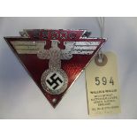 A Third Reich car dashboard (?) triangular plaque, silver plated eagle and swastika on red enamel