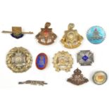 11 lapels and sweetheart badges, including AA gun in shield with scroll “Tenby” tie pin;