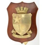 A cast brass badge of HMS Hedingham Castle, corvette 1944-57, showing a quartered shield with a star