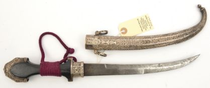 An early 20th century Moroccan jambiya, curved blade 9¼”, DE towards tip, ebony hilt, Eastern silver